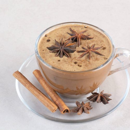 A cup of aroma tasty coffee with cinnamon sticks and star anise . High quality photo